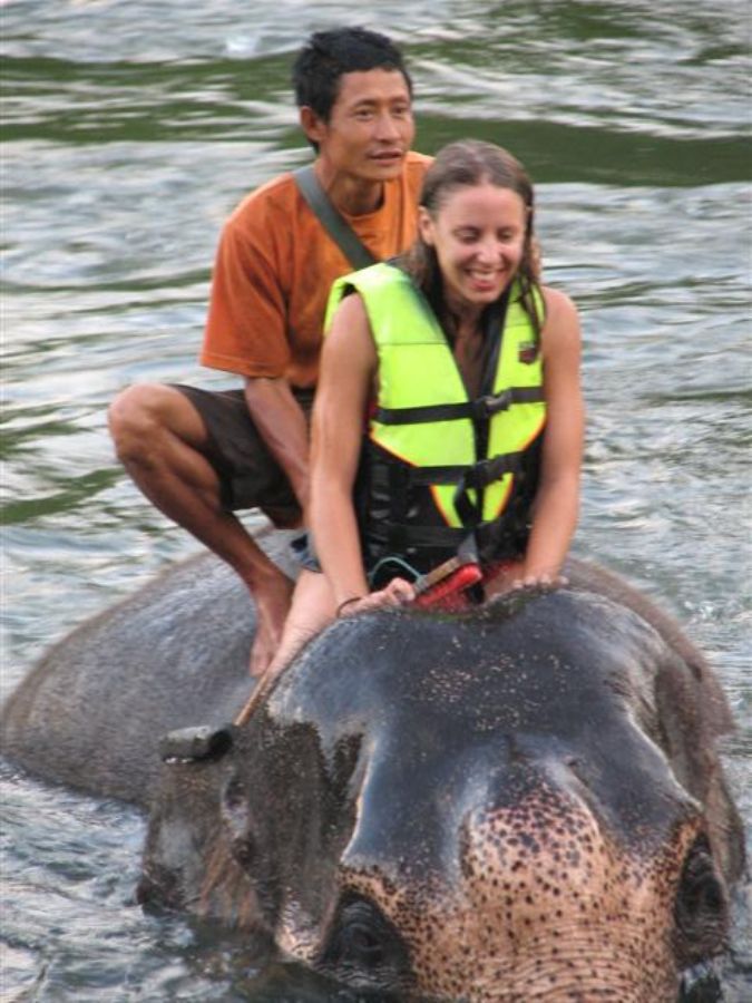 Neta taking a bath with the elephant..